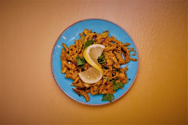 Onion pakora served with lemon