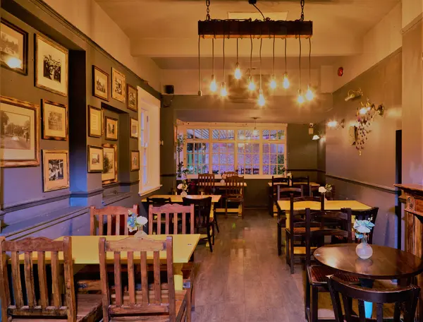 Restaurant dining room lined with framed vintage photographs